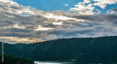 river in the forest and sky on the horizon