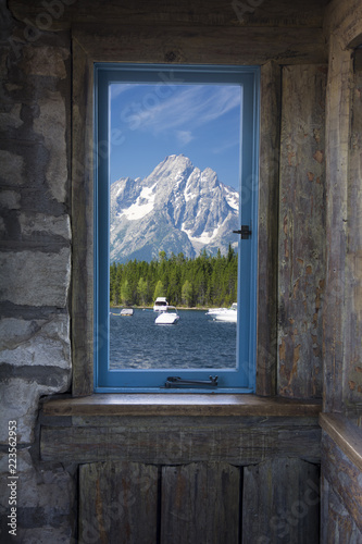 Window view of mountain lake and boats