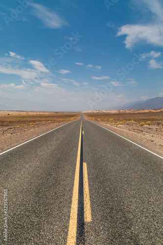 Looking along a long, straight road in Death Valley National Park, California