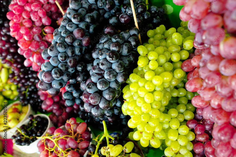 Red grapes background, dark grapes, blue grapes, red grape in local market. Healthy fruits/food concept. Red grapes background, dark grapes, blue grapes, red grape in local market. Healthy fruits/food concept.