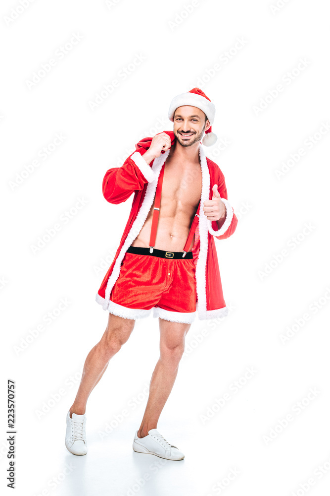 muscular man in santa claus costume with christmas sack doing thumb up isolated on white background muscular man in santa claus costume with christmas sack doing thumb up isolated on white background