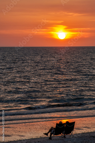 Wallpaper Mural A silhouetted couple in chairs watch the sunset along Bonita Beach in Bonita Springs, Florida. Torontodigital.ca