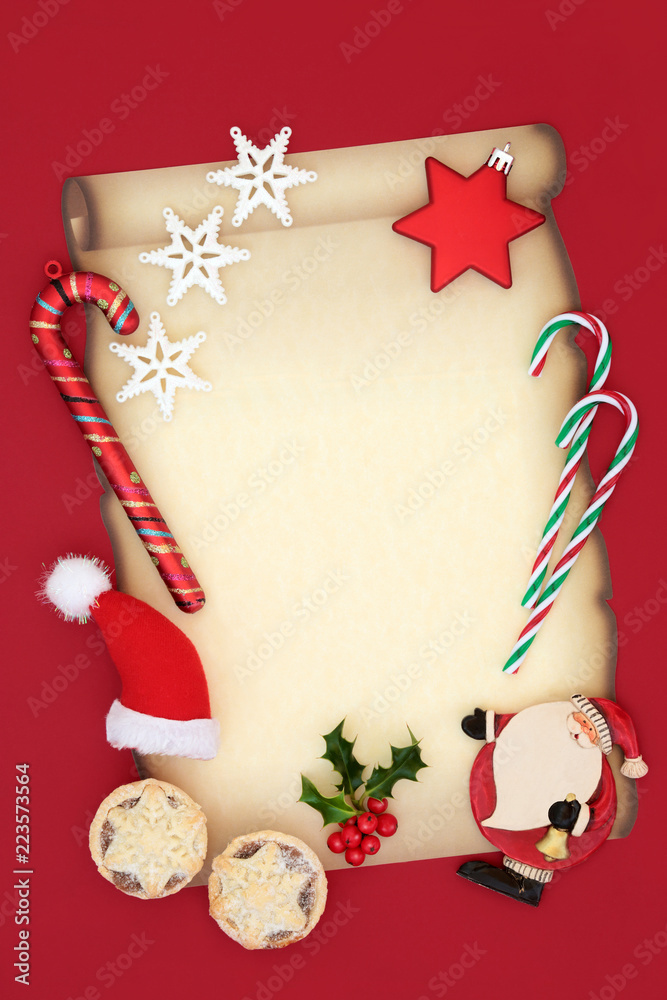 Letter to Santa Claus Christmas eve concept for a party invitation with  blank parchment paper, hat, mince pies, candy canes, star baubles and  winter holly on red background. Stock Photo | Adobe