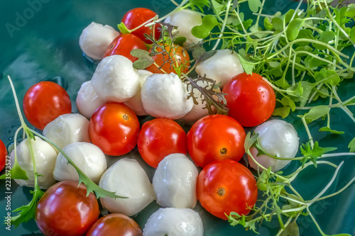 Mozzarella and tomatoes with thyme arugula and Basil. To prepare the salad photo