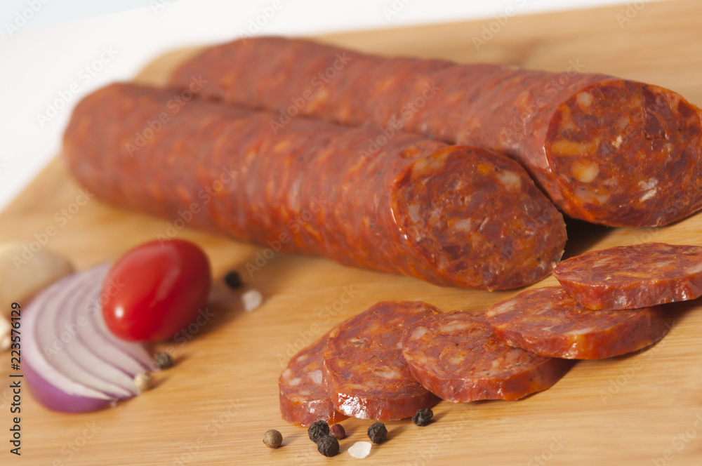 Dry pork hard salami - Hickory smoked sausage on cutting board Dry pork hard salami - Hickory smoked sausage on cutting board