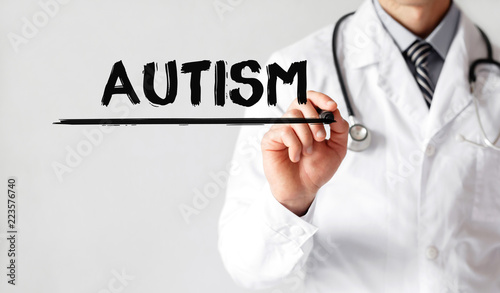 Doctor writing word Autism with marker, Medical concept