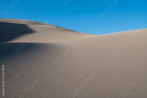 Softly curving sand dunes and shadows in Great Sand Dunes National Park  Colorado