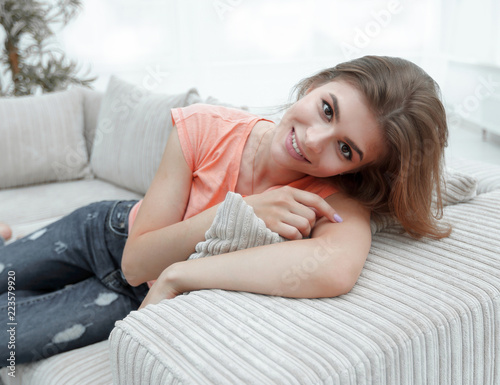 young female student relaxing at home on the couch. © ASDF