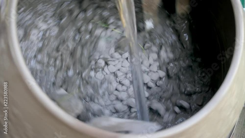 Industrial cement mixer machine at construction site. Add water during mixing. Concrete pouring. Mixes the sand, gravel and water. Close-up. 4k