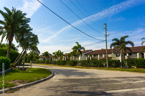 Wallpaper Mural Typical Southwest Florida home in the countryside with palm trees, tropical plants and flowers. Palm Springs is a village in Palm Beach County, Florida, United States, Torontodigital.ca