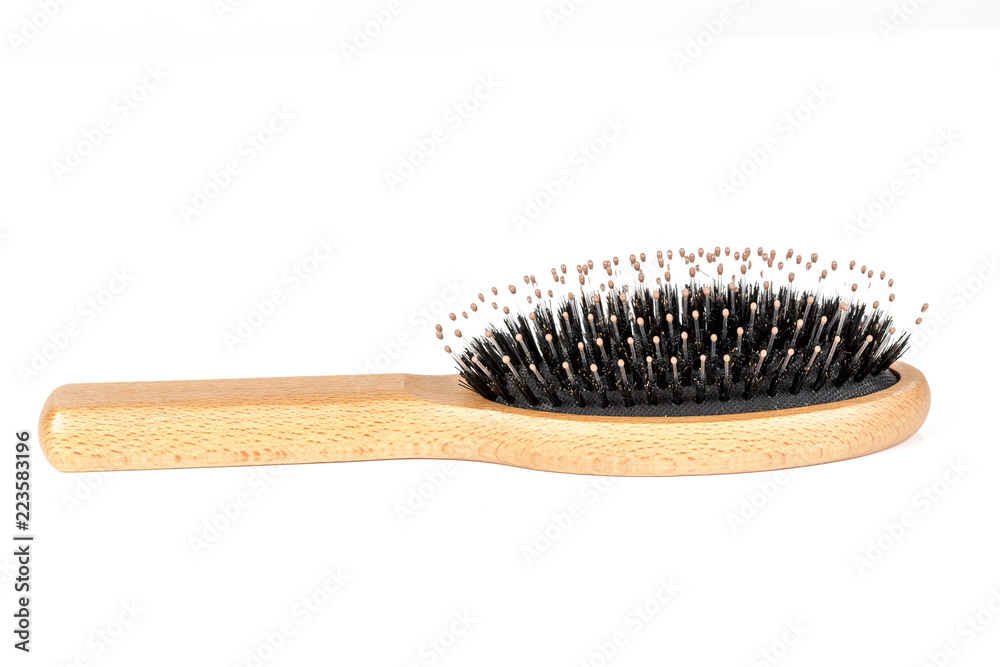 Wood hairbrush on white background. Close-up without hair
