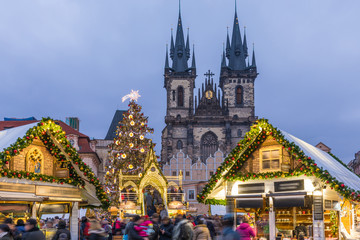 Prague Christmas market on the night in Old Town Square with blurred people on the move. Prague, Czech Republic.