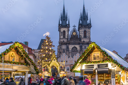 Prague Christmas market on the night in Old Town Square with blurred people on the move. Prague, Czech Republic.