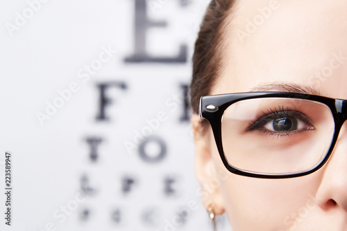 Girl in glasses on the background of a table for vision