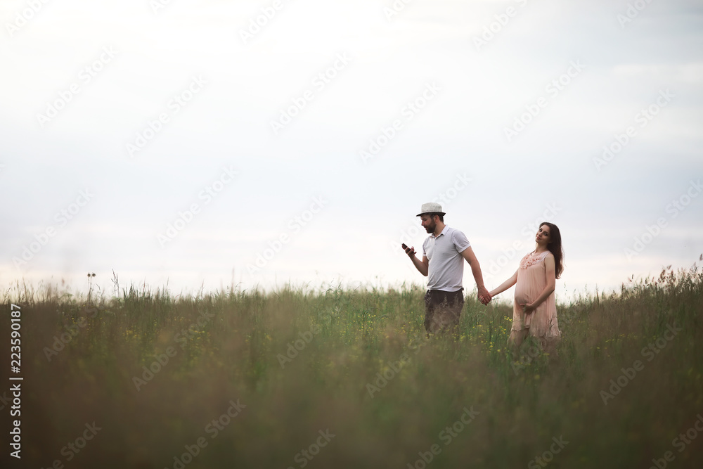 Couple man and pregnant girl in the field Couple man and pregnant girl in the field