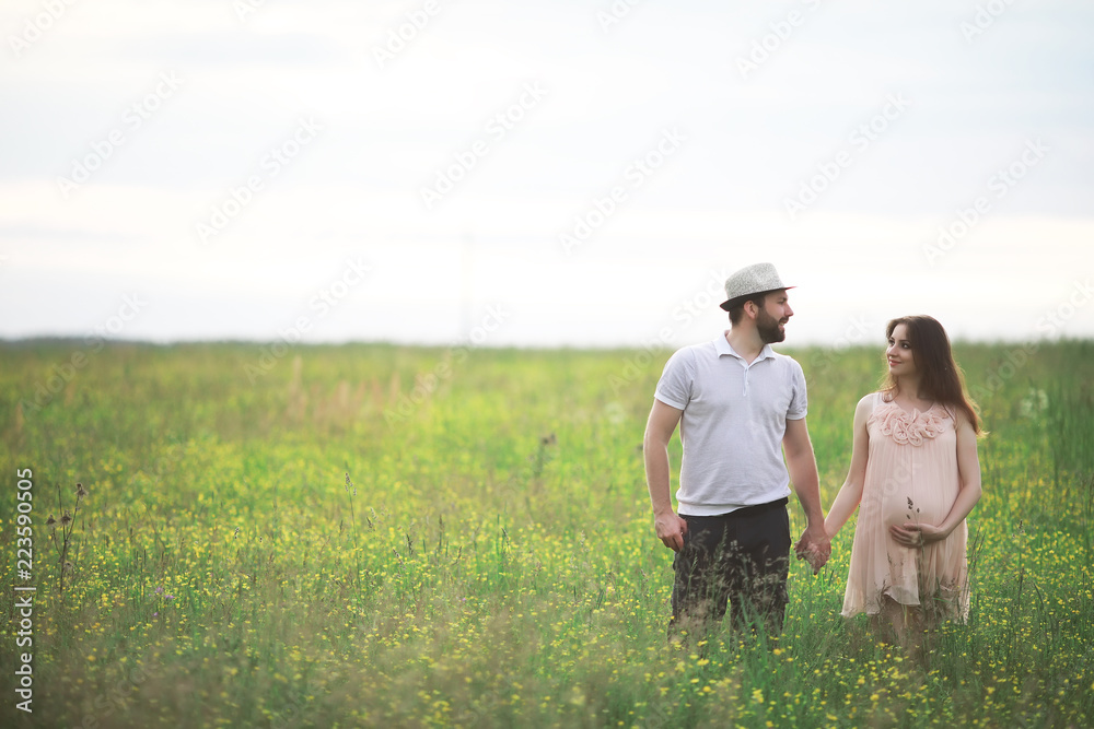 Couple man and pregnant girl in the field Couple man and pregnant girl in the field