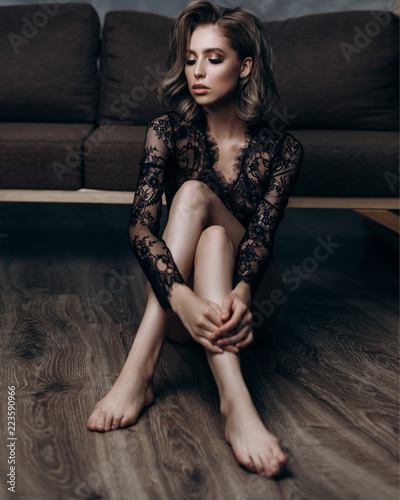 beautiful sexy young blonde woman posing in black lace lingerie © irinaneva