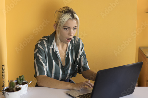 pretty young girl in the office with laptop photo