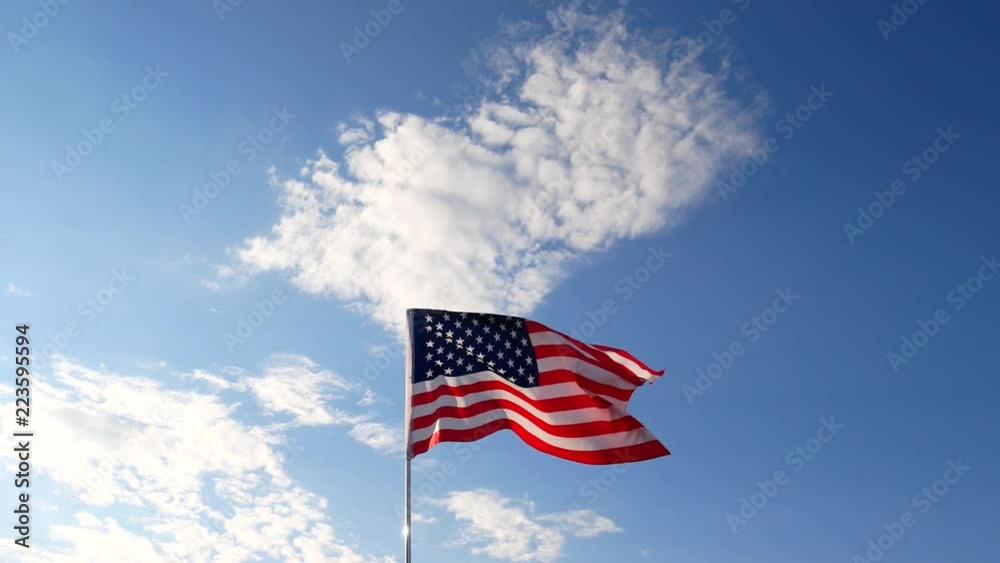 United States of America Flag. The red white and blue. U.S,A, Stars Stripes, flying with blue sky. United States of America Flag. The red white and blue. U.S,A, Stars Stripes, flying with blue sky.