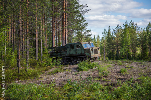 Old soviet artillery tractor by the woods