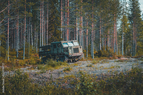 Old soviet artillery tractor by the woods
