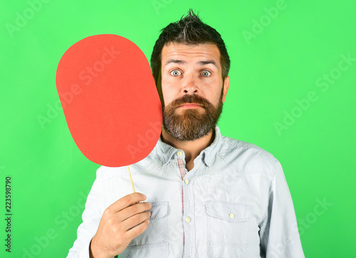 Bearded man surprised face expression holds red name plate. Feeling&emotions. Face expression, life perception. Funny bearded man with cardboard in hand. Amazed man holds empty nameplate. Blank paper.