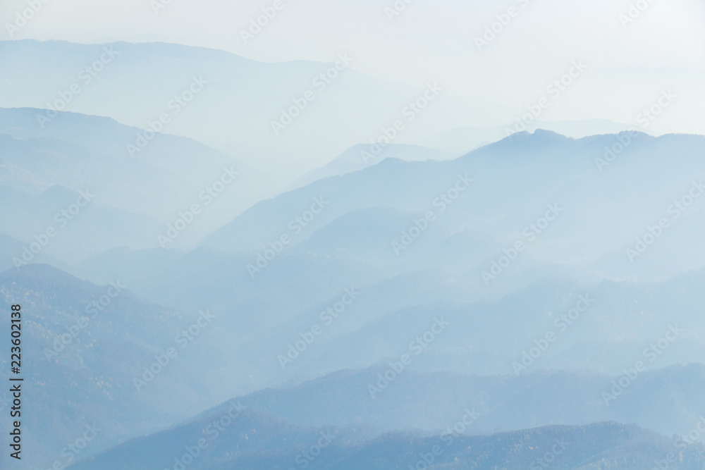 Fototapeta premium Infinite Blue /Dream Valleys. A mood picture where the misty thin veil defines the hills and valley