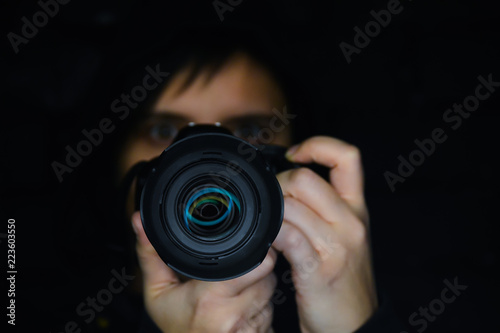 the photographer looks at the camera on a black background