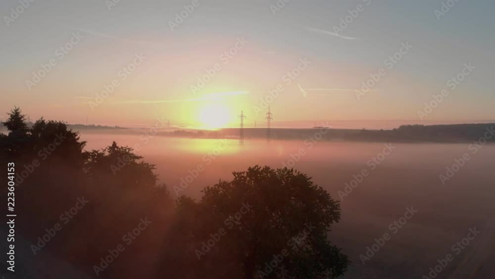 A calm autumn, a fog at dawn, beautiful rays of the sun through the foliage of trees in autumn in the field. A calm autumn, a fog at dawn, beautiful rays of the sun through the foliage of trees in autumn in the field.