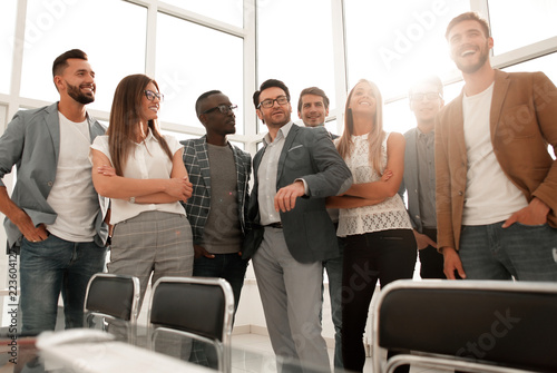 boss and business team standing in bright office