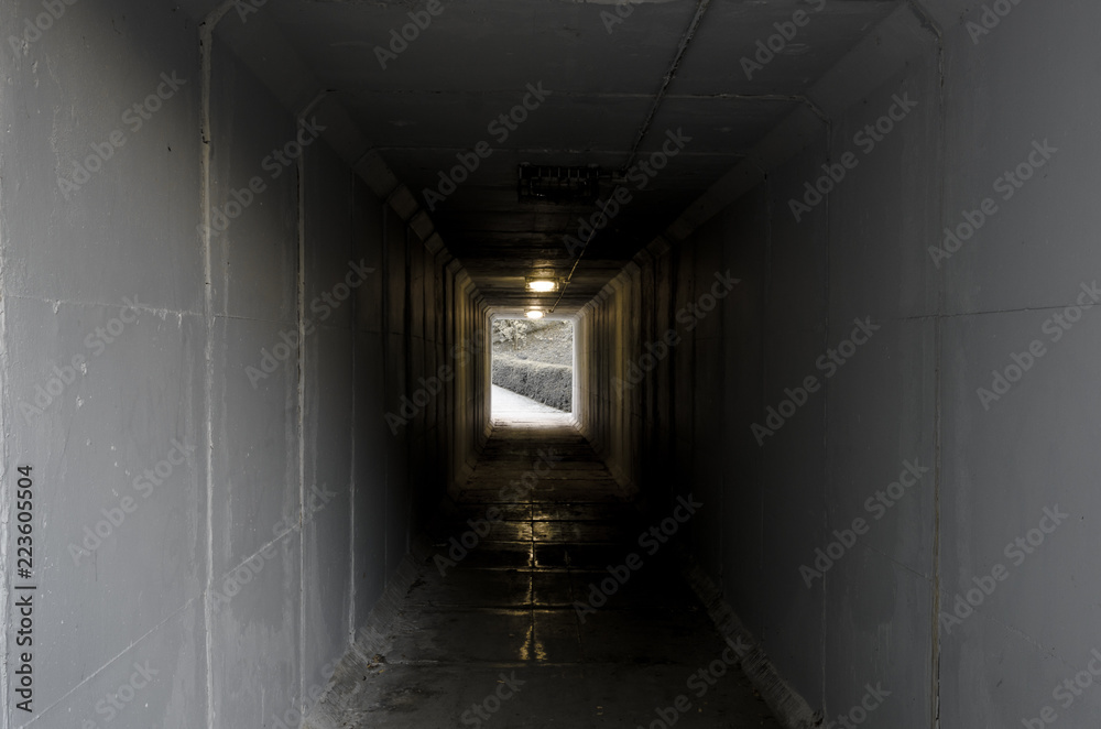 Cement tunnel with light at the end