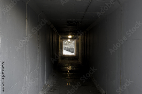 Cement tunnel with light at the end