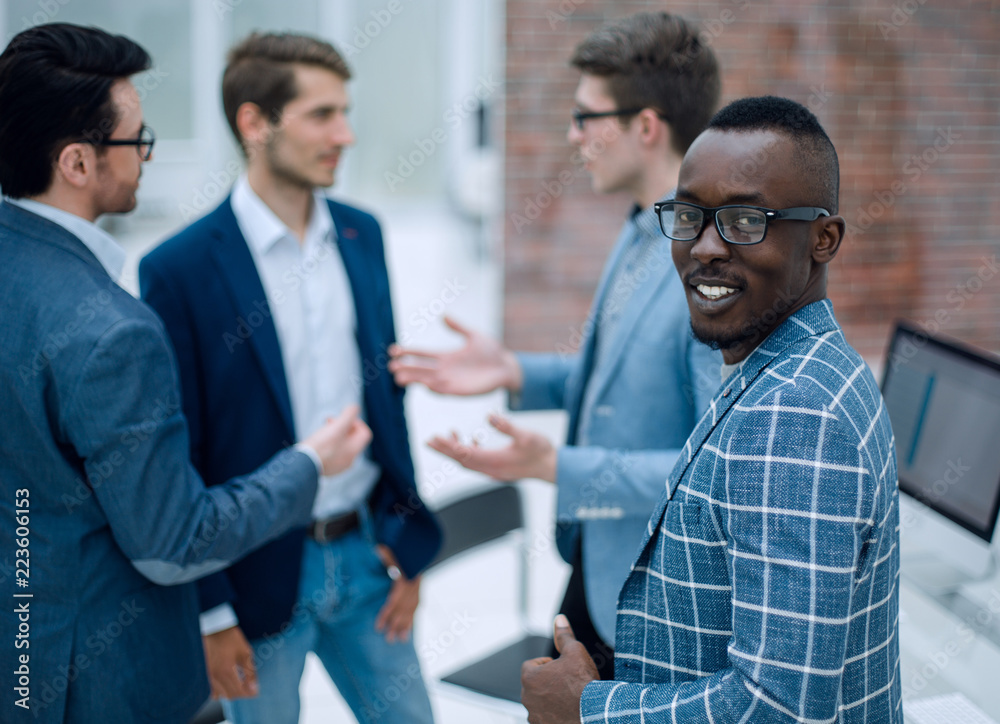 young businessman in front of his colleagues young businessman in front of his colleagues