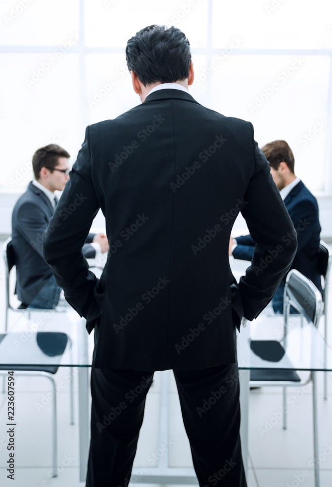 Fototapeta premium rear view.businessman standing in the conference room