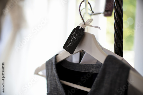 Close-up of dress hanging on coathanger at home during wedding