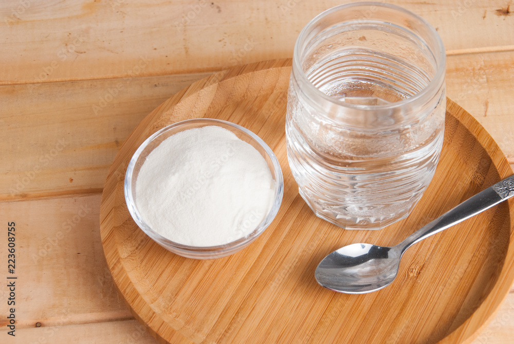 Hydrolyzed collagen protein on wooden table Hydrolyzed collagen protein on wooden table