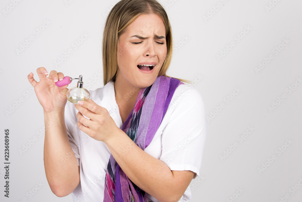 bad perfume smell concept beautiful girl holding bottle, size plus model bad perfume smell concept beautiful girl holding bottle, size plus model
