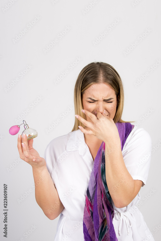 bad perfume smell concept beautiful girl holding bottle, size plus model bad perfume smell concept beautiful girl holding bottle, size plus model