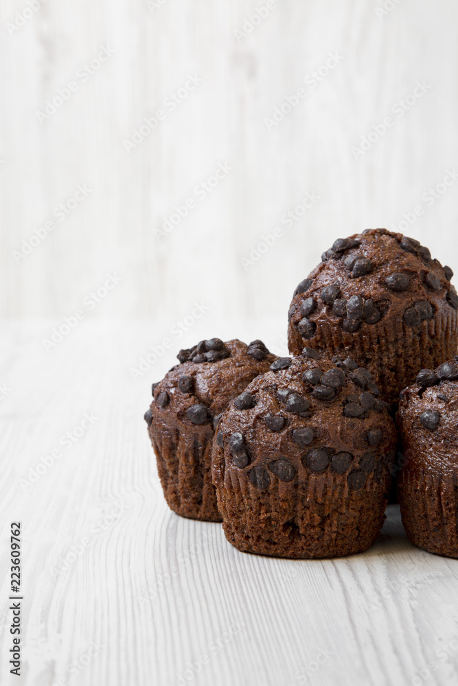 Chocolate muffins on white wooden background, side view. Close-up. Copy space. Chocolate muffins on white wooden background, side view. Close-up. Copy space.