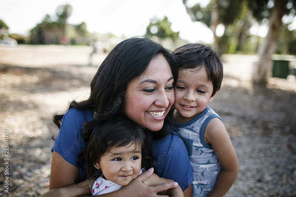 Happy mother playing with children at park Happy mother playing with children at park