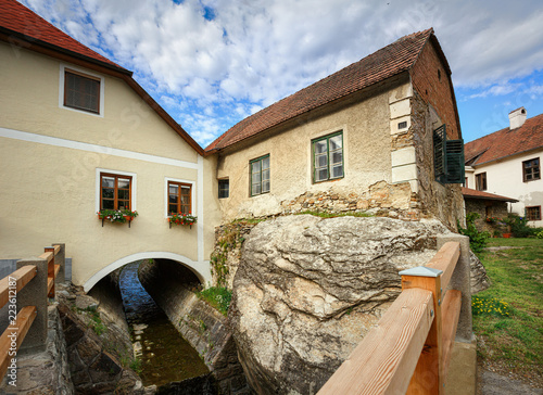 Old residential house on the rocky bank over a ditch. Weissenkirchen in der Wachau, Lower Austria. photo