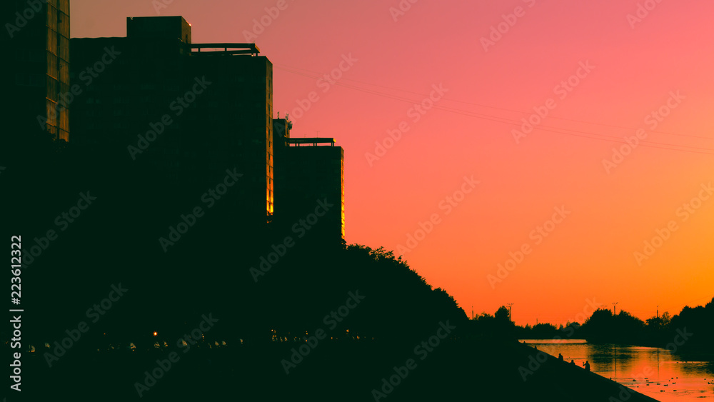 red sky at sunset with buildings in shadow