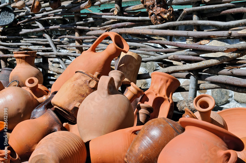 Crude clay jugs and handmade carved pots.