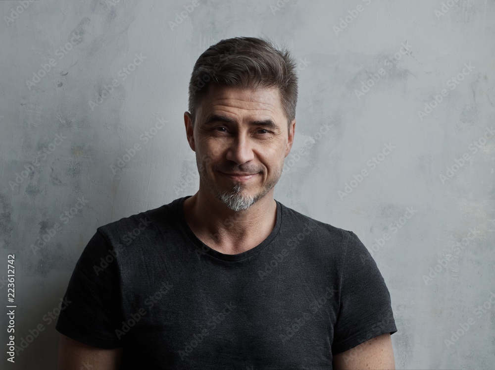 Happy older man in casual tshirt smiling