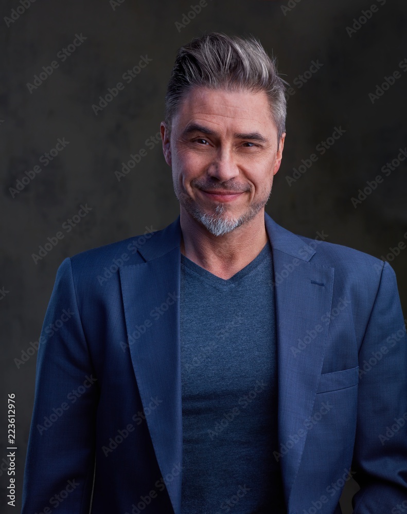 Happy older businessman in jacket smiling