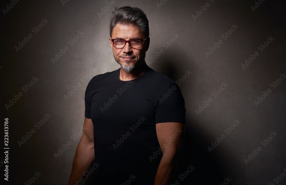 Portrait of an older white guy dark background