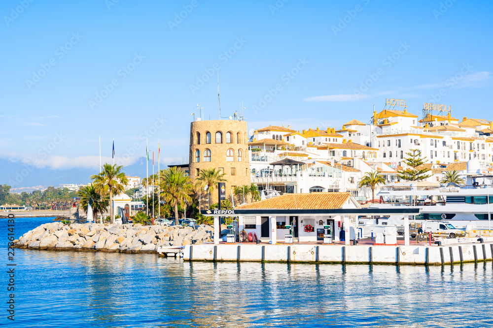 View of Puerto Banus marina with boats and white houses in Marbella town, Andalusia, Spain