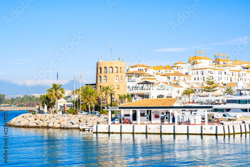 View of Puerto Banus marina with boats and white houses in Marbella town, Andalusia, Spain photo