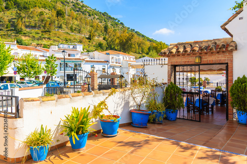 Terrace with flowerpots and white houses in picturesque village of Mijas, Andalusia. Spain