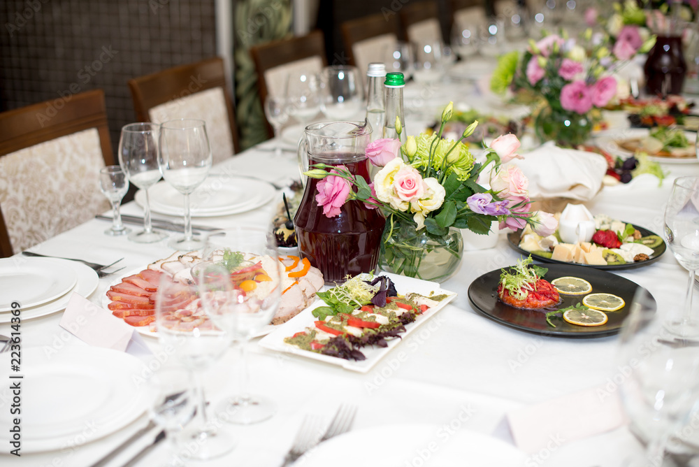 Served for a banquet table. Wine glasses with napkins, glasses and salads